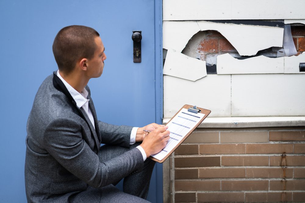 real estate property appraisal, man inspecting house