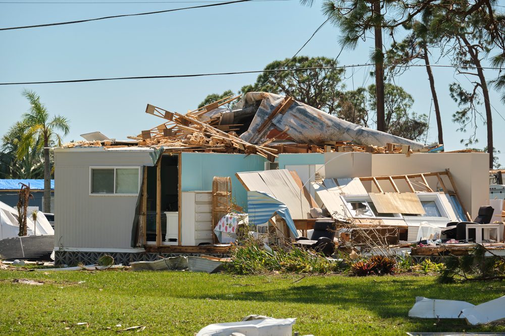 severely damaged house after hurricane Ian in Florida mobile home residential area