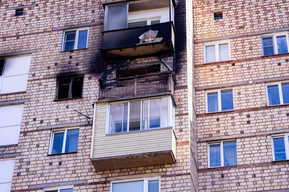 Fire damage on the balcony of a multi-story apartment building in the city